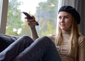 What hobbies are commonly seen as red flags by women? a woman sitting on a couch