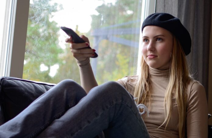 Photo by Anna Kasin a woman sitting on a couch