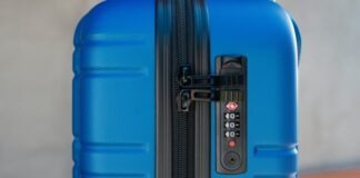 a blue piece of luggage sitting on top of a wooden table