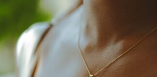 woman wearing silver cross pendant necklace