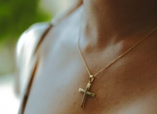 5 Stunning Cross Chain Pieces to Add to Your Collection woman wearing silver cross pendant necklace