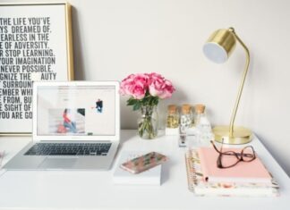 Benefits of Using Stock Photographs MacBook Air beside gold-colored study lamp and spiral books