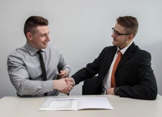 All you Need to Know about Beneficiaries two men facing each other while shake hands and smiling