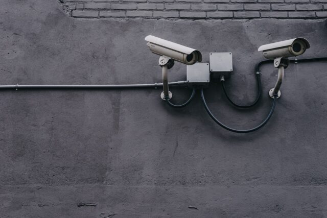 Photo by Scott Webb two bullet surveillance cameras attached on wall