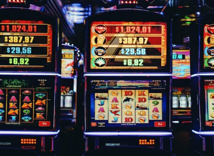 Photo by Nathana Rebouças a row of slot machines sitting next to each other