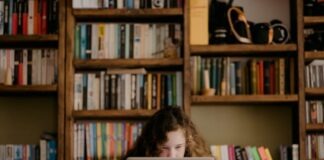 woman in black long sleeve shirt using macbook