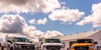 green and yellow chevrolet car on brown sand under blue and white sunny cloudy sky during