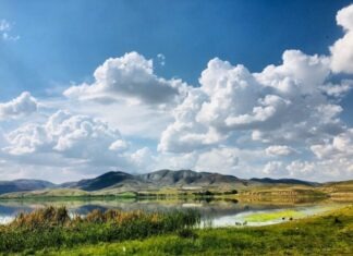 What are Weather Fronts? A Guide for Kids! green grass field near lake under white clouds and blue sky during daytime