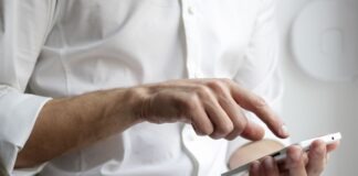 person holding white Android smartphone in white shirt