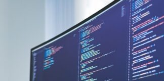 a computer monitor sitting on top of a wooden desk