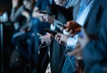 The Impact of Social Media on Harlem Politics people using phone while standing