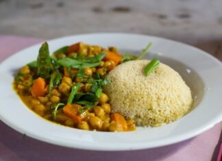 Easy Curry Chickpeas Recipe rice with green leaf vegetable on white ceramic plate
