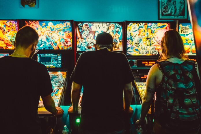 Photo by Louie Castro-Garcia people playing arcade machines