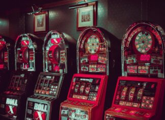 Colorful slot machines in a casino, flashing lights and spinning reels.