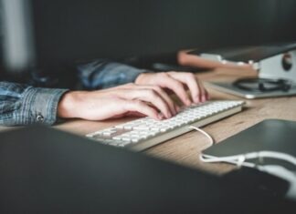 Payment Processing to Sell Software person using computer keyboard