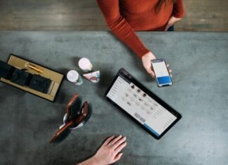 Exploring the Dark Side of Financial QR Code Transactions person holding smartphone beside tablet computer