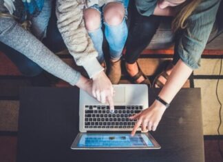 Creating a Powerful Online Presence for Real Estate: Web Development Best Practices three person pointing the silver laptop computer