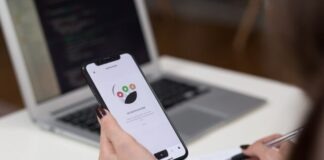person holding space grey iPhone X turn on