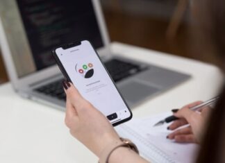 5 Essential Productivity Apps for Busy Professionals person holding space grey iPhone X turn on