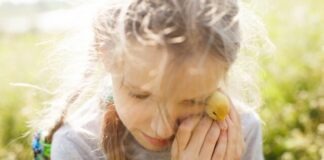 woman in gray long sleeve shirt holding yellow fruit