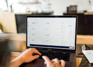 Online Gold Platforms: The Cost-Effective Gateway To Gold Investment person using MacBook pro