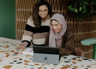 12 Ways Technology is Revolutionizing Small Business Operations Two women sitting at a table with a laptop