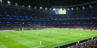 two teams playing soccer inside stadium