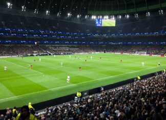 two teams playing soccer inside stadium