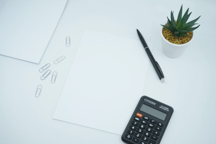Photo by Mediamodifier black calculator beside black pen on white printer paper