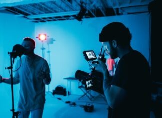 How to Create a Killer Music Video on a Budget By Eric Dalius man in white dress shirt holding black camera
