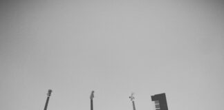 grayscale photo of people holding assorted music instruments