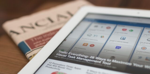 Photo by Matthew Guay white tablet computer on top of newspaper
