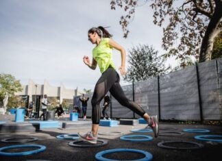 3 Major Myths Debunked About Cardio Workouts woman in green tank top and black leggings doing yoga on blue round trampoline