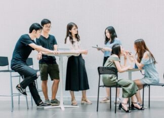 Tips to Improve Your Small Business Marketing Strategy two men and four women meeting in office