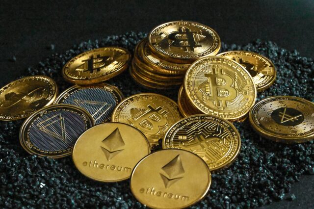 Photo by Traxer a pile of bitcoins sitting on top of a pile of gravel