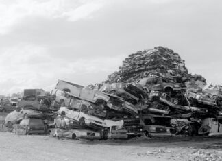 grayscale photo of wrecked cars on field