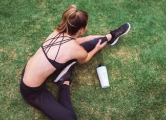 woman in black lingerie holding white bottle