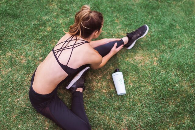 Photo by LyfeFuel woman in black lingerie holding white bottle