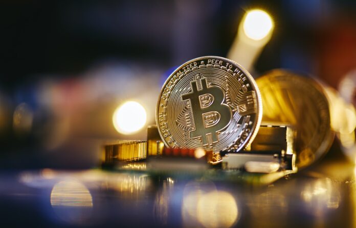 Photo by Michael Förtsch a bitcoin sitting on top of a computer chip