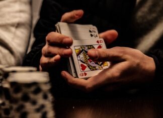 person holding king of spade playing card
