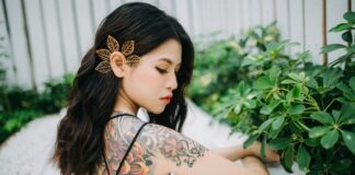 women's orange and black floral back tattoo