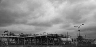 grayscale photo of train on rail tracks