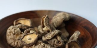 brown and black coffee beans in brown wooden bowl