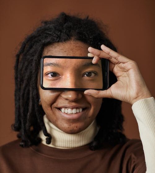 free-a-woman-holding-a-smartphone-with-eyes-pictur Free A Woman Holding a Smartphone with Eyes Picture on Screen Stock Photo