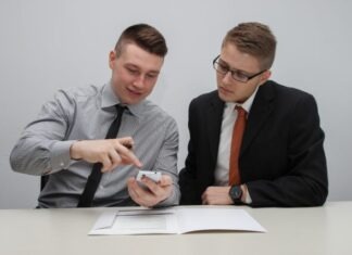 A Comparison Between Smart Contracts and Traditional Contracts two man watching smartphone