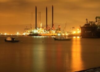 Influence of Seasonality on Oil Trading city skyline during night time