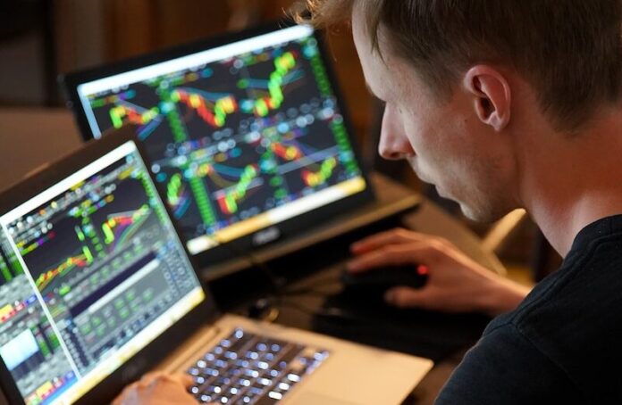 Photo by Adam Nowakowski man sitting in front of the laptop