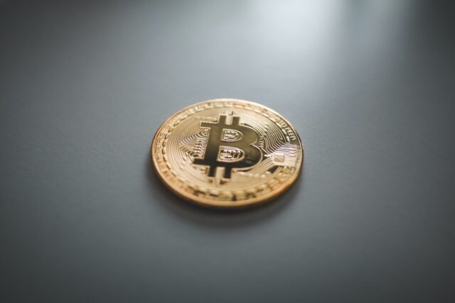 Photo by Nick Chong gold round coin on gray surface