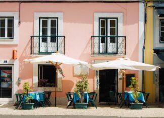 The Rise of Commercial Umbrellas: More Than Just Shade two white patio umbrellas near pink and white painted concrete building