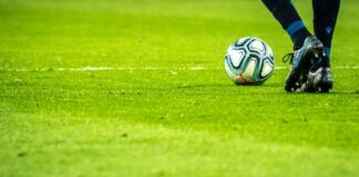 man playing soccer game on field